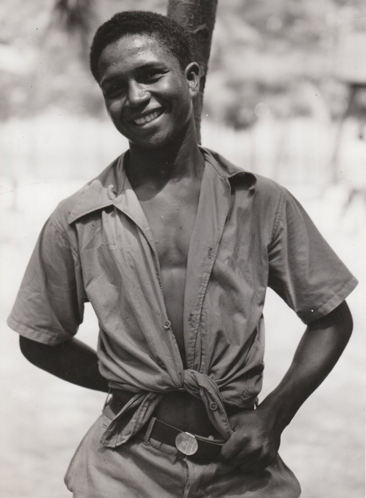 A young Puerto Rican man, happy to have a job in the National Youth Administration. Photo courtesy of the National Archives (ca. 1935-1943).