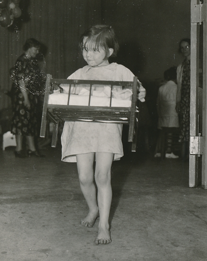 A new toy is always a good thing. A young girls leaves a WPA toy loan project in Atlanta, Georgia. Photo courtesy of the National Archives (May 1938).