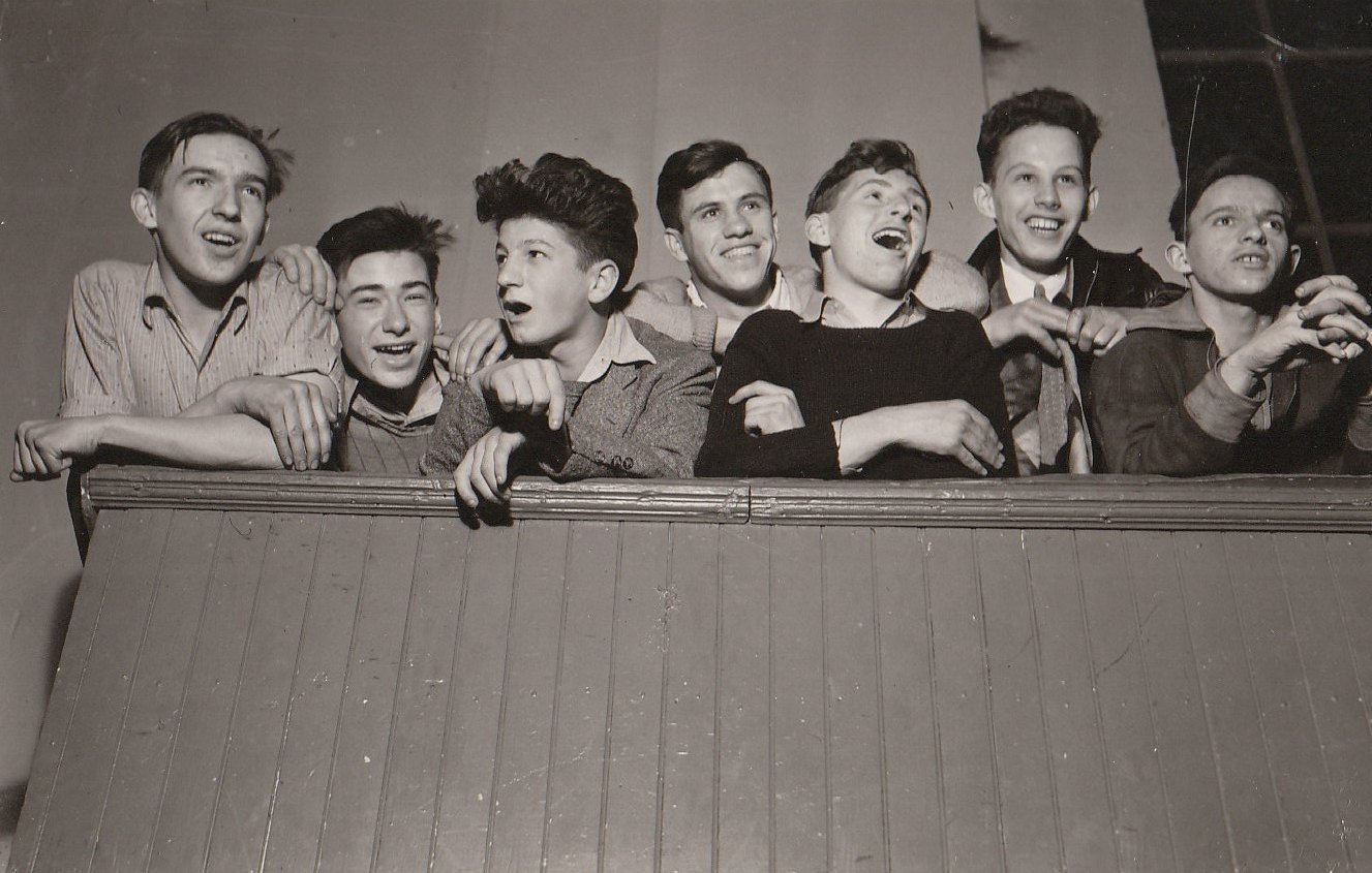 Young men happily singing folk songs at a WPA recreation center in Baltimore, Maryland. Photo courtesy of the National Archives (1938).