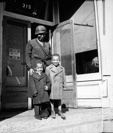 Two boys are happy to have new overcoats, from an NYA-run surplus commodities shop in Salem, Virginia. Photo courtesy of the National Archives and the New Deal Network (ca. 1935-1939).