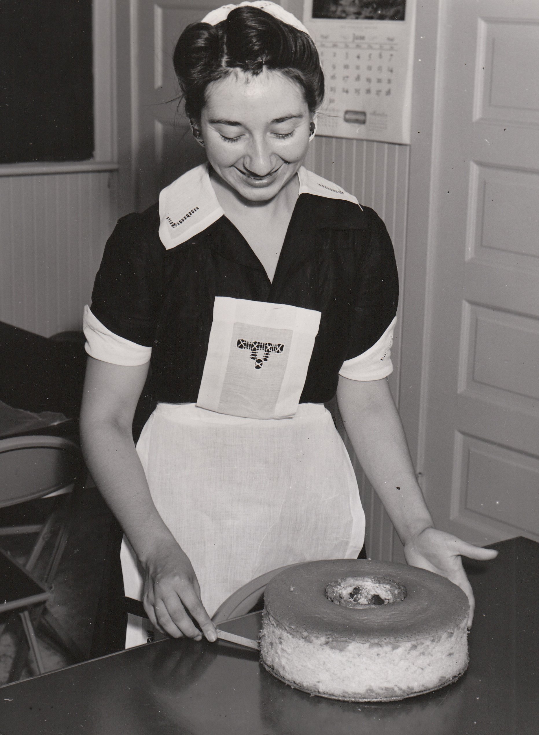 Binnie Mitchell, an NYA student worker at Pasadena Junior College (California), seems quite satisfied with her tempting creation. Photo courtesy of the National Archives (ca. 1935-1943).